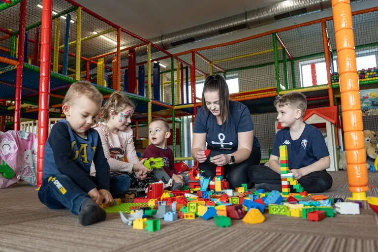 Deti a animátorka sa hrajú s legom v detskom kútiku vo Villa Betula Resort.